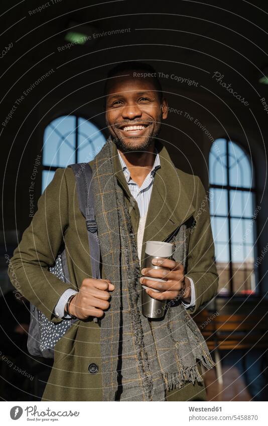 Portrait of happy stylish man with reusable cup in the train station business life business world business person businesspeople Business man Business men