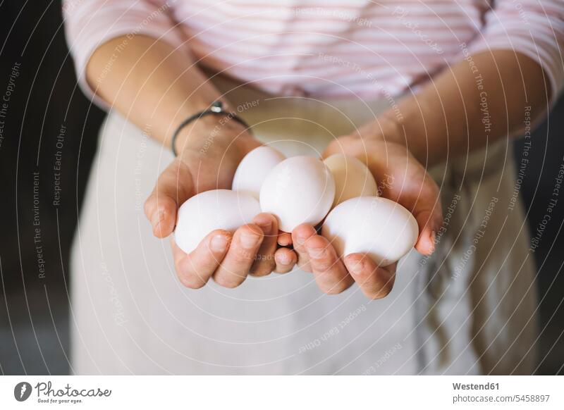 Woman holding raw white eggs uncooked Egg Eggs hand human hand hands human hands woman females women preparation prepare preparing Food foods food and drink