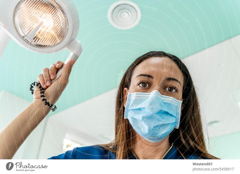 Doctor with adjustable light working in dentist's clinic color image colour image indoors indoor shot indoor shots interior interior view Interiors Spain