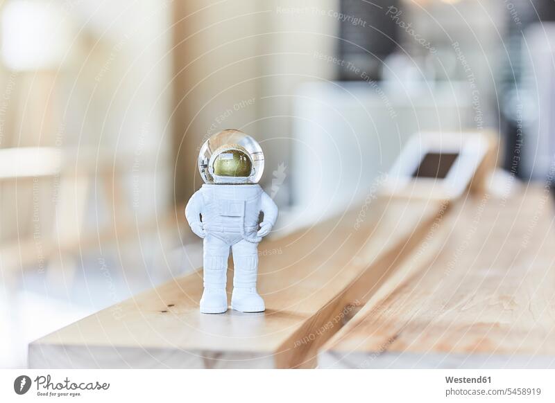 Miniature astronaut figurine on wooden bench AI contemporary figurines faux Focus In The Foreground focus on the foreground Ideas little developing Developments