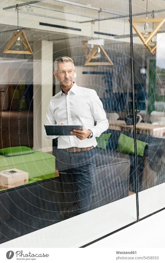 Mature businessman in office lounge looking out of window human human being human beings humans person persons caucasian appearance caucasian ethnicity european