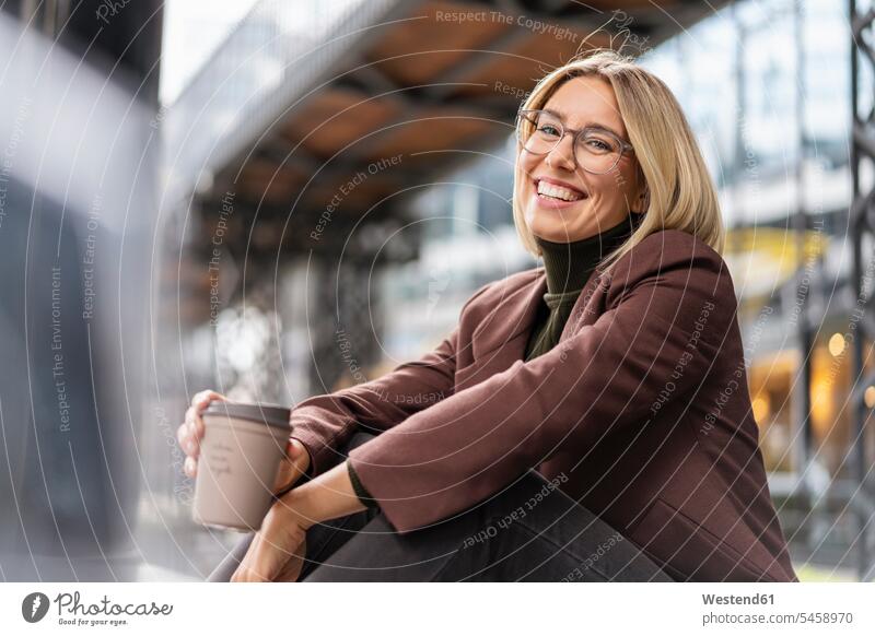 Portrait of happy young businesswoman with takeaway coffee in the city business life business world business person businesspeople business woman business women