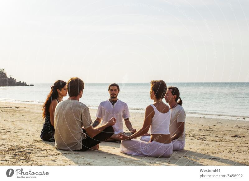 Thailand, Koh Phangan, group of people meditating together on a beach Group groups of people beaches meditate persons human being humans human beings friends