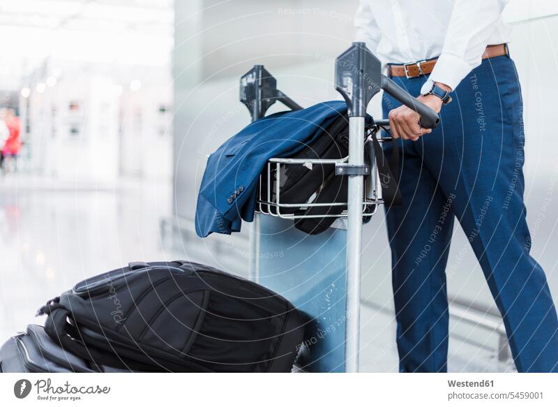 Businessman using baggage cart luggage cart baggage carts luggage carts men males Business Trip executive travel Business Trips Business Travel Business Travels