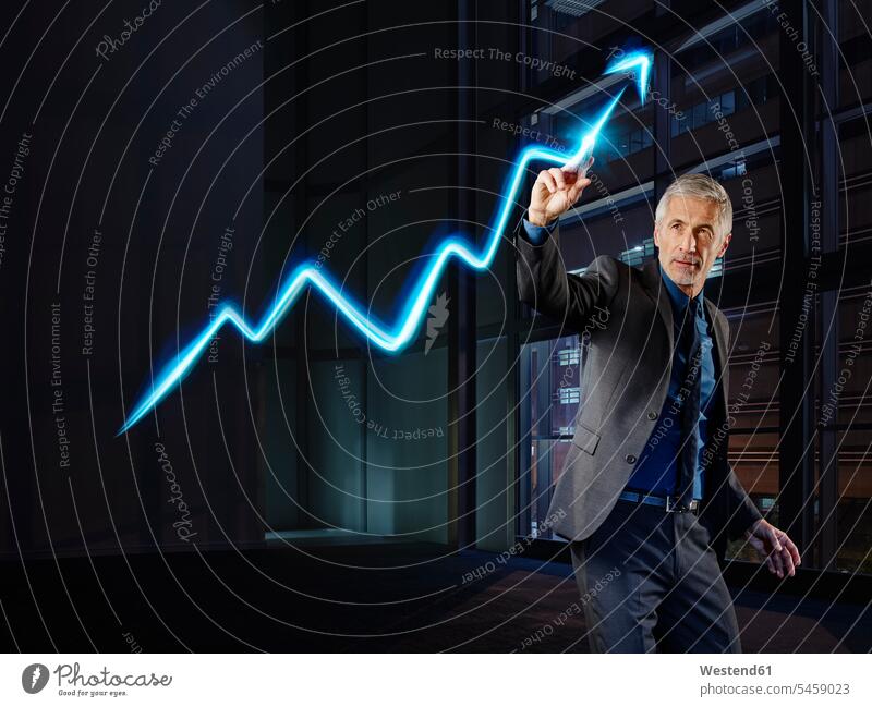 Businessman painting the stock market development with light Business man Businessmen Business men broker trader stocks and shares financial market