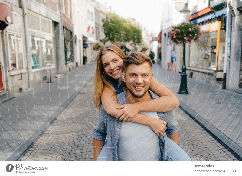 Netherlands, Maastricht, portrait of happy young couple in the city twosomes partnership couples portraits happiness town cities towns people persons