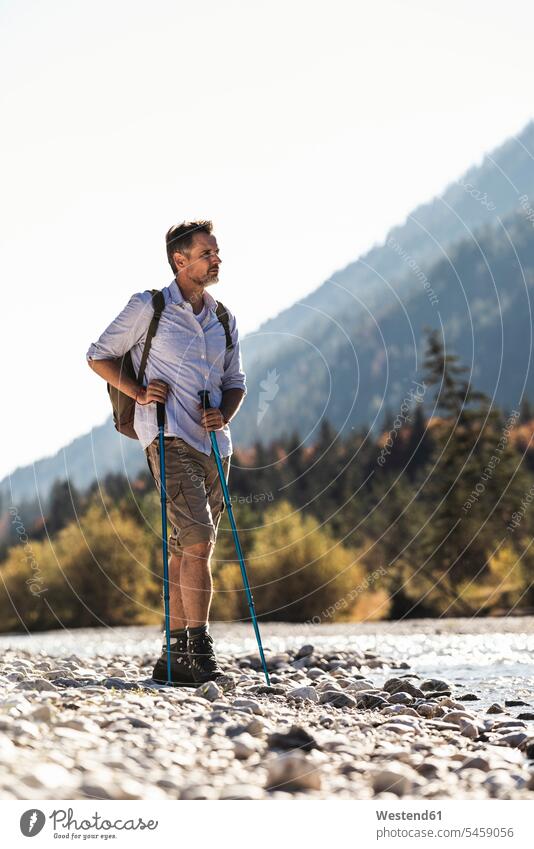 Austria, Alps, man on a hiking trip standing on pebbles at a brook caucasian caucasian appearance caucasian ethnicity european White - Caucasian mature men
