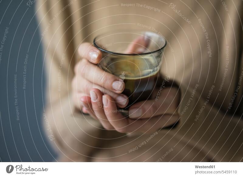 Woman's hands holding glass of coffee, close-up woman females women human hand human hands Coffee Glass Drinking Glasses Adults grown-ups grownups adult people