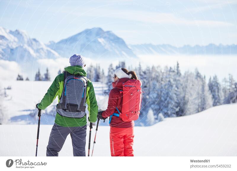 Austria, Tyrol, snowshoe hikers leisure free time leisure time winter hibernal Looking At View Looking at a view snowshoeing standing couple twosomes