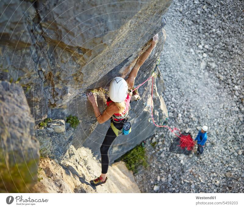 Austria, Innsbruck, Martinswand, woman climbing in rock wall rock face escarpment rocks females women Adults grown-ups grownups adult people persons human being