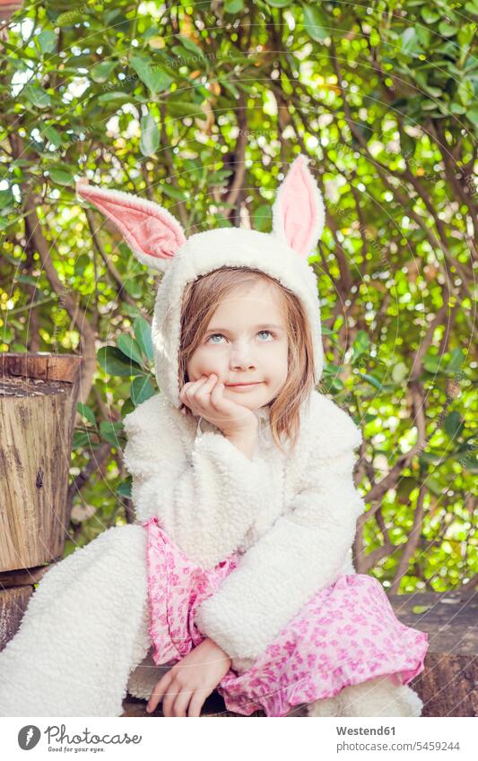 Portrait of little girl wearing Easter bunny costume hoods smile Seated sit Contented Emotion pleased colour colours magenta Rosy Humor Humorous Ideas