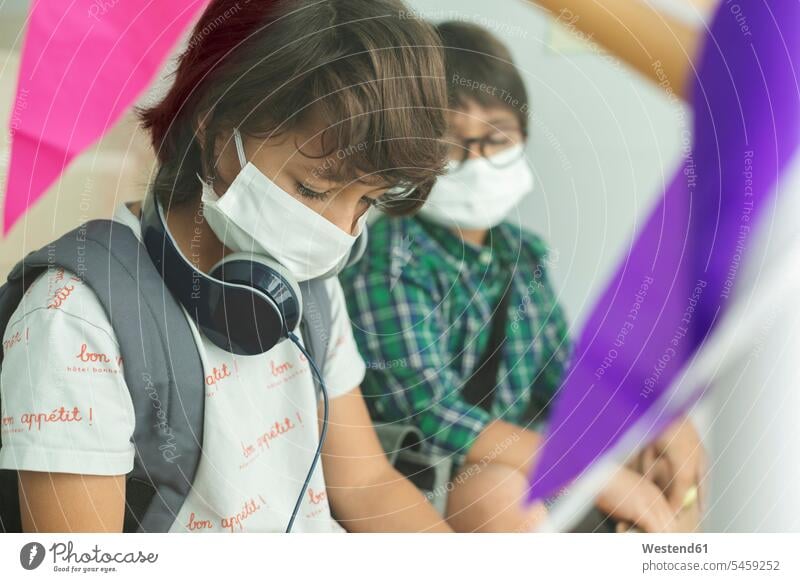 Close-up of boys wearing masks maintaining social distance while sitting in school color image colour image Spain 10-11 years 10 to 11 years children kid kids