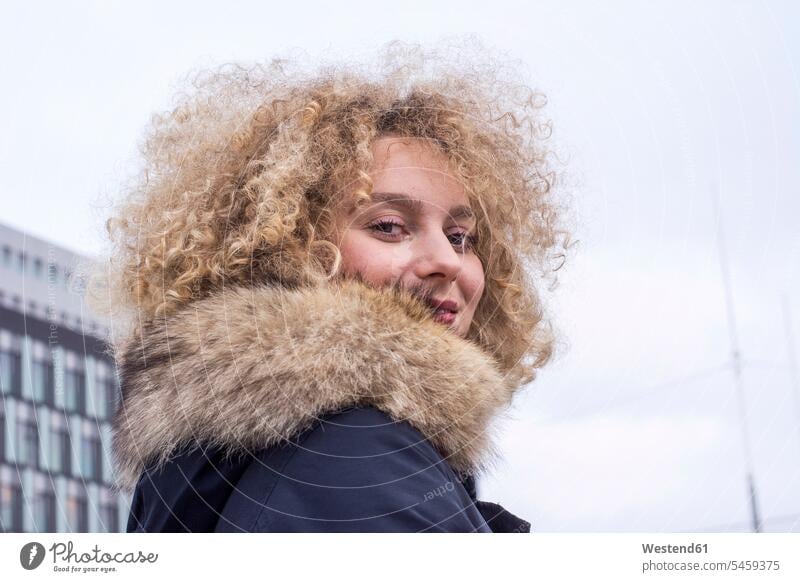 Portrait of smiling blond woman with ringlets wearing fur collar females women smile portrait portraits blond hair blonde hair Adults grown-ups grownups adult