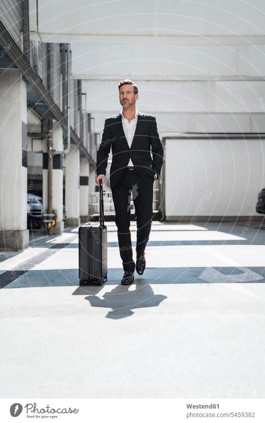 Businessman with baggage on the go human human being human beings humans person persons caucasian appearance caucasian ethnicity european 1 one person only
