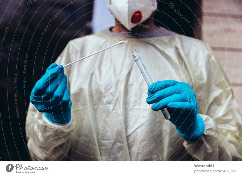Healthcare worker holding swab test kit for PCR testing human human being human beings humans person persons caucasian appearance caucasian ethnicity european 1