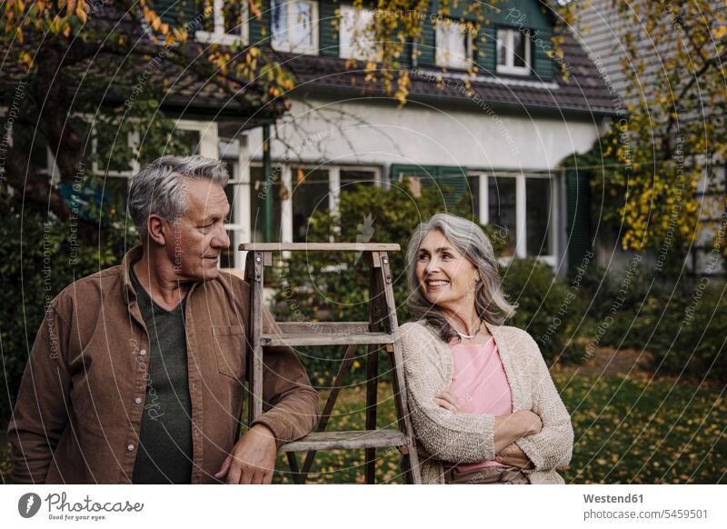 Senior couple with a ladder in garden of their home human human being human beings humans person persons caucasian appearance caucasian ethnicity european 2