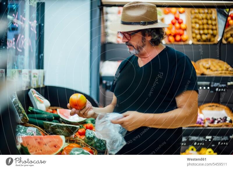 Senior man buying food in a supermarket human human being human beings humans person persons caucasian appearance caucasian ethnicity european 1 one person only