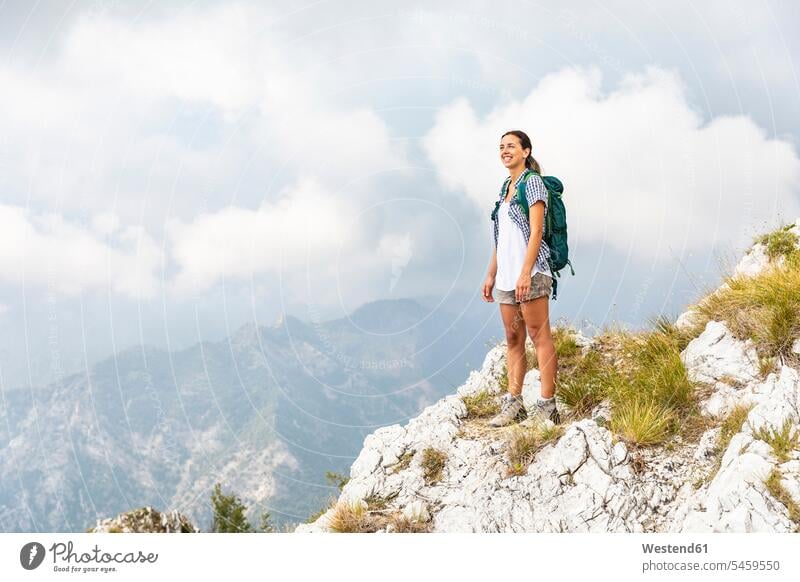 Italy, Massa, young woman on top of the mountain in the Alpi Apuane standing mountains summit mountaintops summits mountain top females women mountain range