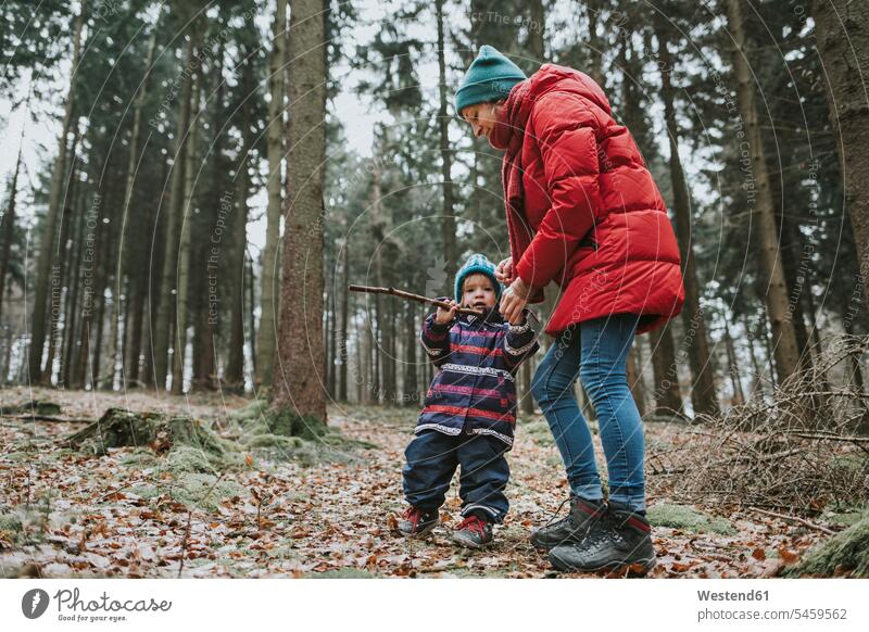 Mother with little daughter in autumnal forest woods forests autumnally daughters mother mommy mothers ma mummy mama fall child children family families people