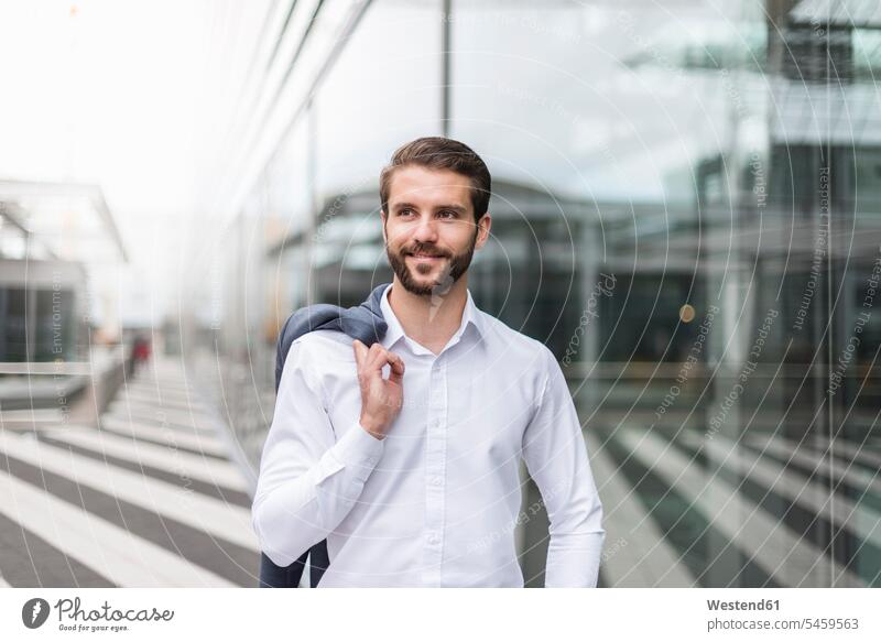 Portrait of smiling young businessman at glass facade Businessman Business man Businessmen Business men portrait portraits smile Glass front business people