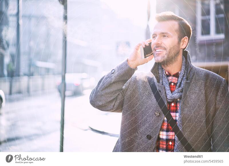 Portrait of smiling man on the phone in winter portrait portraits call telephoning On The Telephone calling men males smile telephone call Phone Call