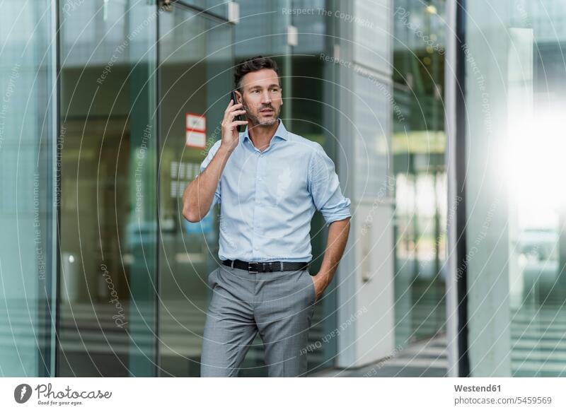Businessman on the phone outside building Occupation Work job jobs profession professional occupation business life business world business person