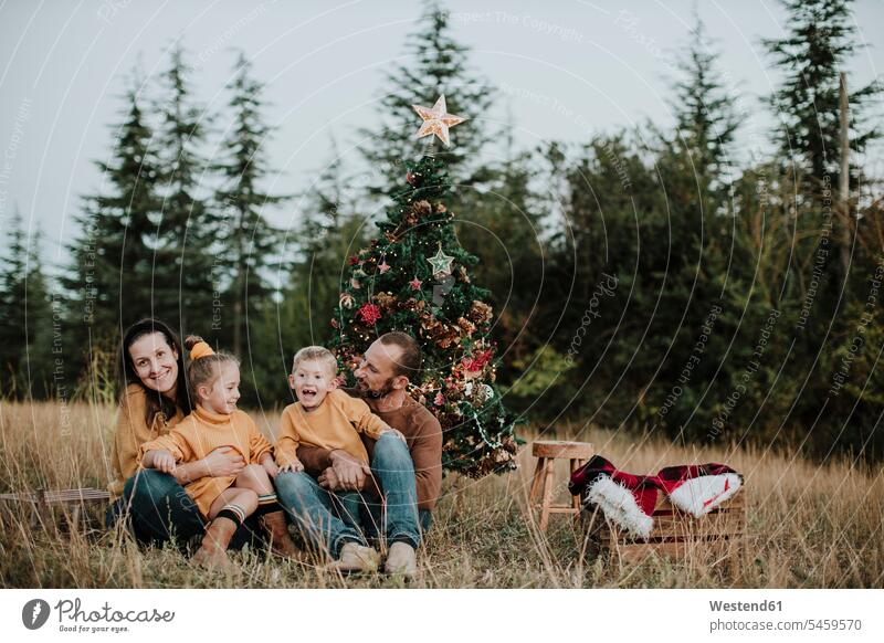 Family celebrating Christmas at countryside during sunset color image colour image Spain outdoors location shots outdoor shot outdoor shots X mas X-Mas Xmas