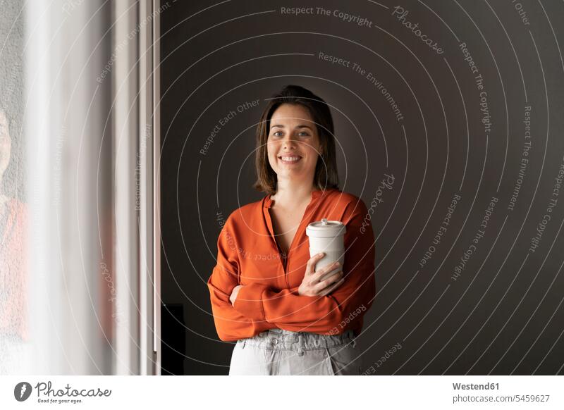 Portrait of smiling businesswoman with coffee cup at home color image colour image indoors indoor shot indoor shots interior interior view Interiors day