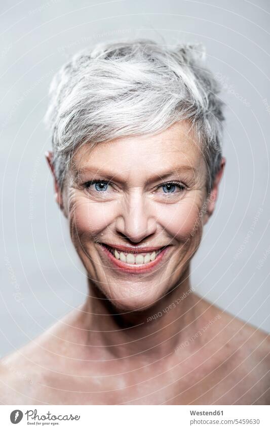 Portrait of laughing mature woman with short grey hair and blue eyes portrait portraits gray short hair cropped hair shorthaired short-haired females women