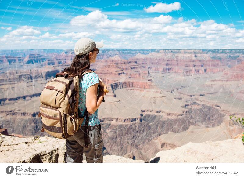 USA, Arizona, Grand Canyon National Park, Young woman with backpack exploring and enjoying the landscape indulgence enjoyment savoring indulging Traveller
