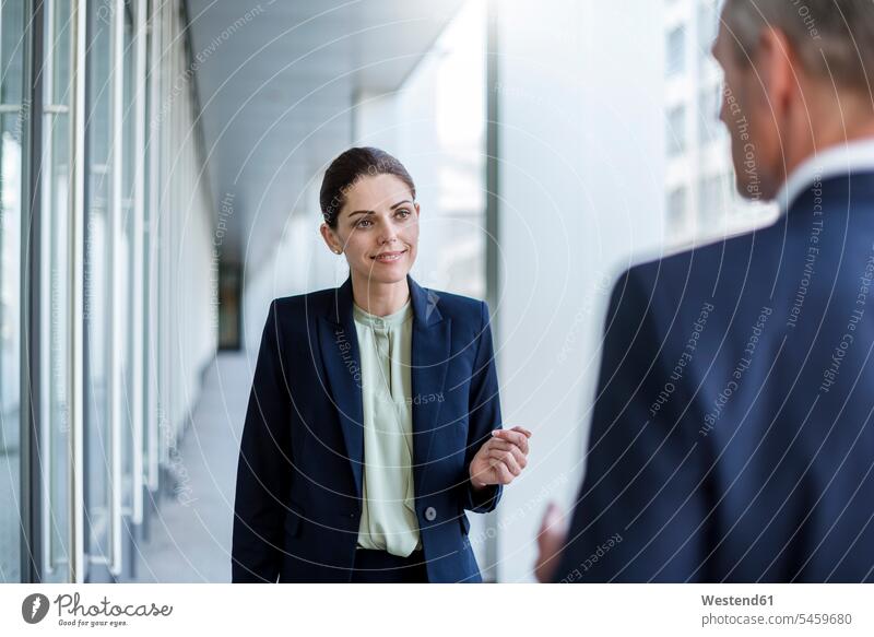 Portrait of smiling businesswoman listening to business partner portrait portraits associates business associates business partners smile businesswomen