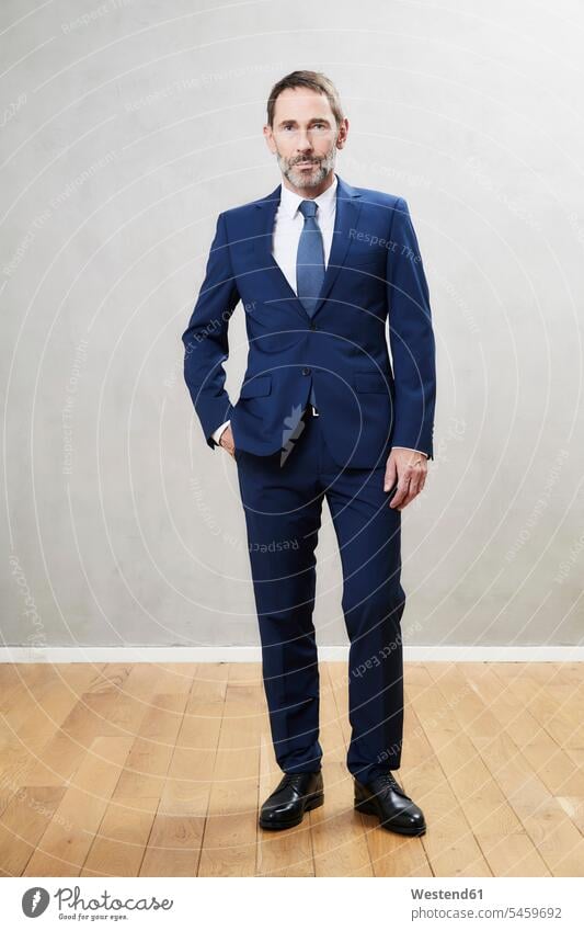 Businessman wearing dark blue suit respectable reliable serious earnest Seriousness austere Fullsuit suits full suit looking at camera looking to camera