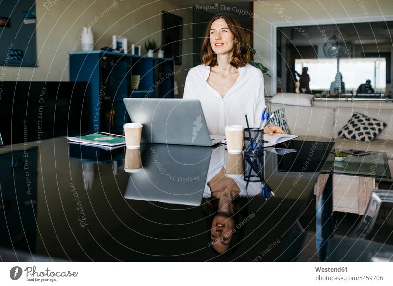 Woman working on table at home with notebook and laptop human human being human beings humans person persons caucasian appearance caucasian ethnicity european 1