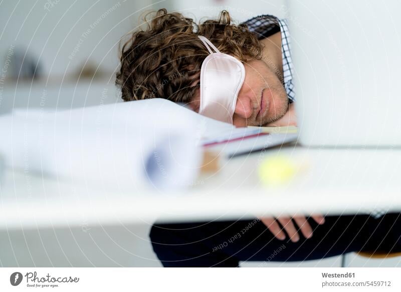 Overworked businessman sleeping at his desk wearing a sleeping mask Businessman Business man Businessmen Business men asleep Sleep Mask Sleeping Mask Office