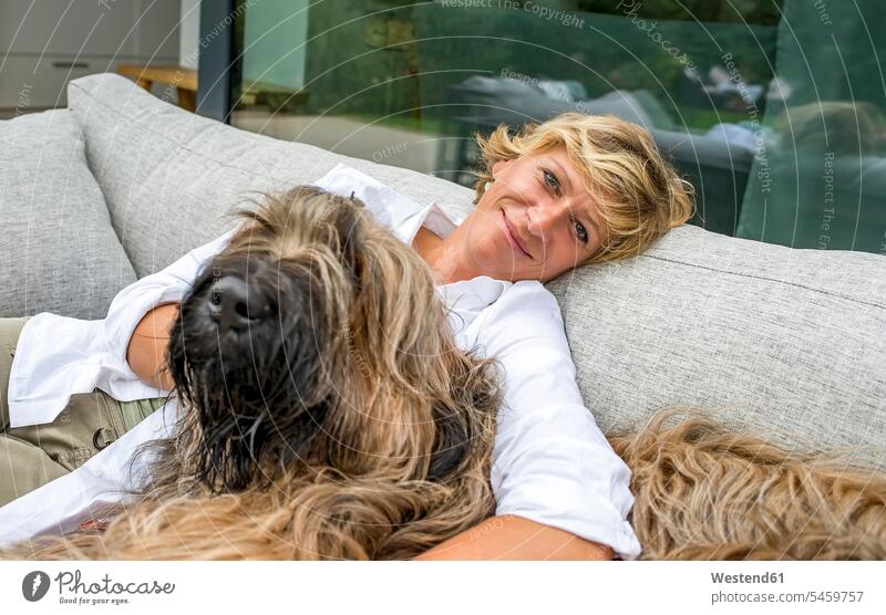 Portrait of woman relaxing with dog on terrace at home human human being human beings humans person persons celibate celibates singles solitary people