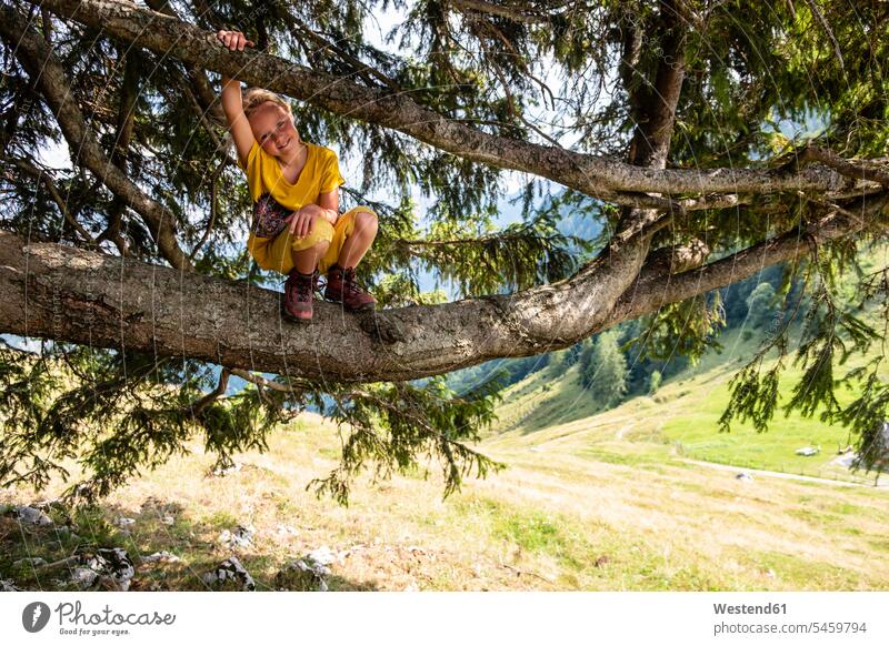 Portrait of smiling girl crouching in a tree Tree Trees cowering smile females girls child children kid kids people persons human being humans human beings