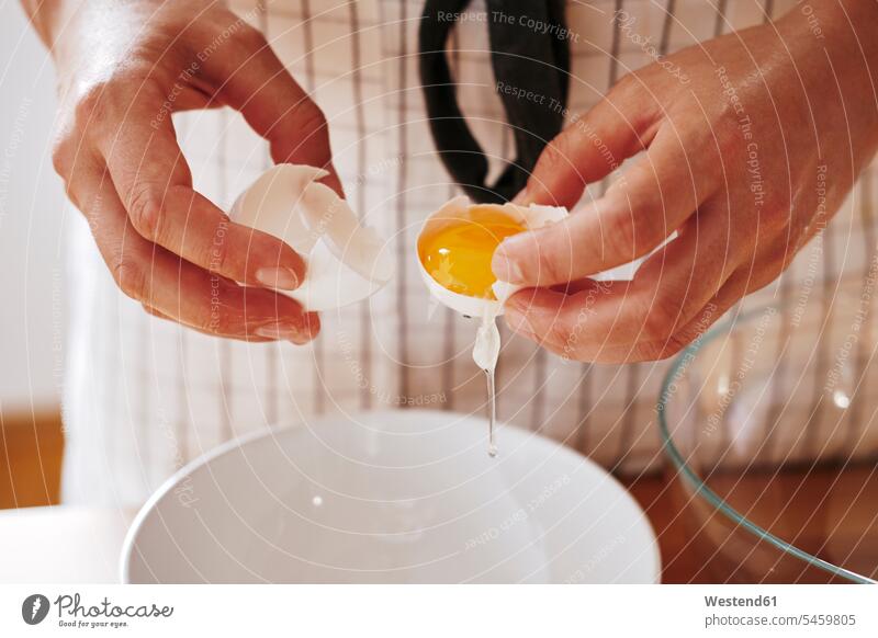 Woman's hands separating egg, close-up woman females women human hand human hands Egg Eggs Adults grown-ups grownups adult people persons human being humans