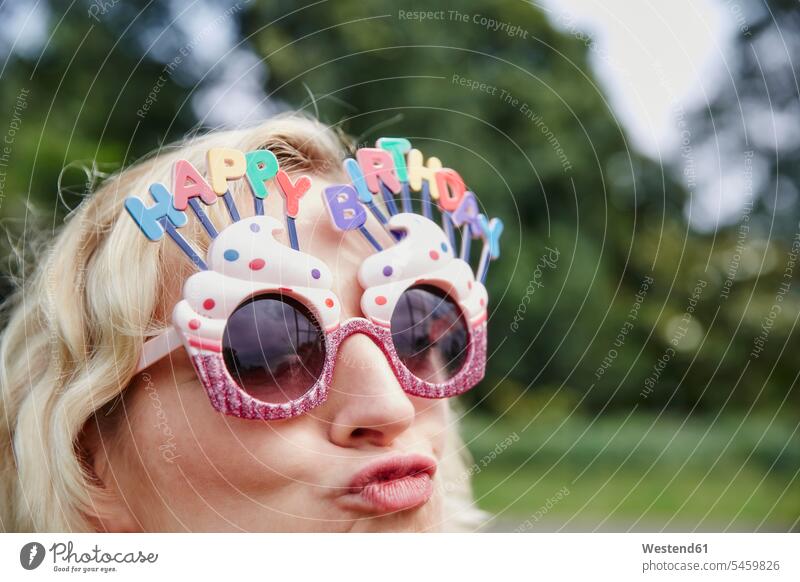 Woman pouting wearing birthday eyeglasses specs Eye Glasses spectacles Eyeglasses woman females women Birthday Birthday Celebration Birthdays