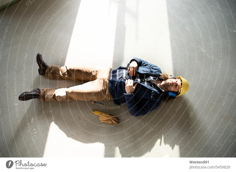 Construction worker sleeping on floor in renovating house color image colour image Germany Architecture construction site Building Site Building Sites