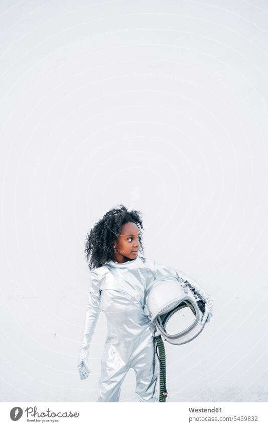 Little girl wearing space suit in front of white background looking around transport space travel spacemen astronauts gloves stand experience Experiences