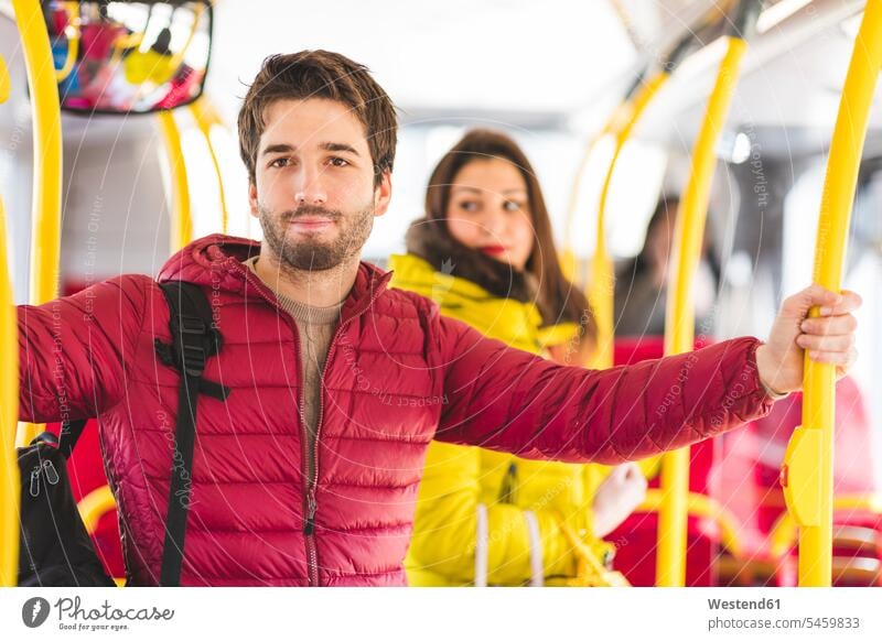 UK, London, portrait of young man travelling by bus men males busses portraits traveling Adults grown-ups grownups adult people persons human being humans