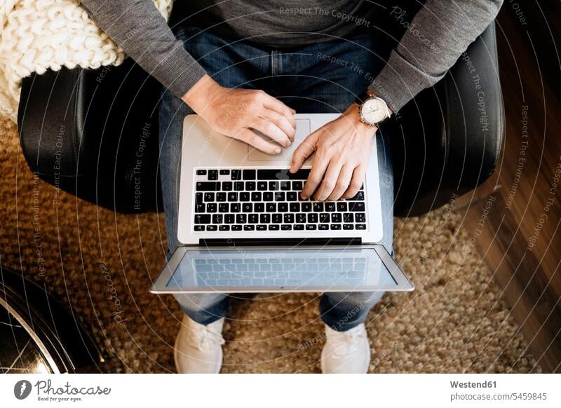 Man sitting at home, using laptop, close-up human human being human beings humans person persons caucasian appearance caucasian ethnicity european 1