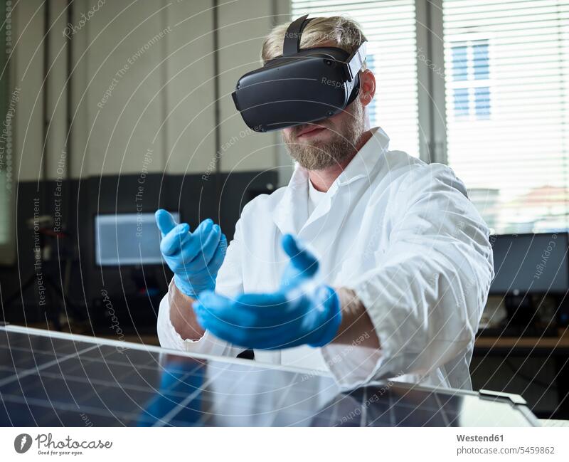 Technician with VR glasses and solar panel in lab human human being human beings humans person persons caucasian appearance caucasian ethnicity european 1