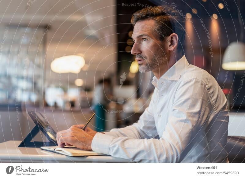 Businessman with tablet in a cafe taking notes human human being human beings humans person persons caucasian appearance caucasian ethnicity european 1