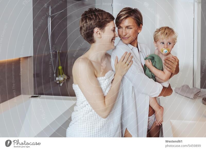 Happy lesbian couple and their little son in the bathroom happiness happy twosomes partnership couples Domestic Bathroom bath room sons manchild manchildren