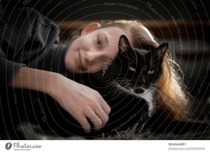 Girl cuddling with black cat animals creature creatures domestic animal pet cats domestic cats house cat house cats portraits human human being human beings
