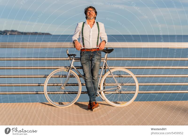 Man with fixie on a jetty shirts transport bikes bicycles bike - bicycle Cycle Cycle - Vehicle Eye Glasses Eyeglasses specs spectacles smile basking sun bath