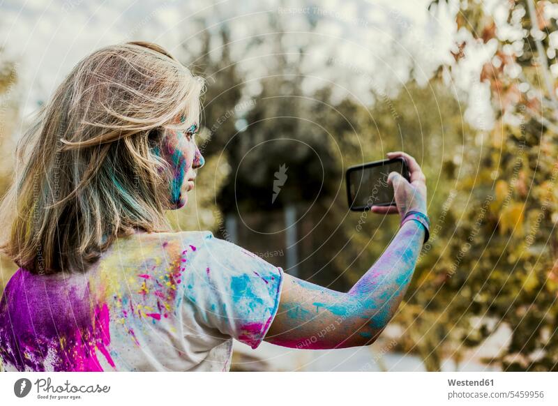 Gir Holi powder colours in her face, taking selfie, Germany mobile phone mobiles mobile phones Cellphone cell phone cell phones Standing Out From The Crowd