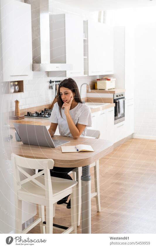 Young woman using laptop at home human human being human beings humans person persons celibate celibates singles solitary people solitary person Occupation Work