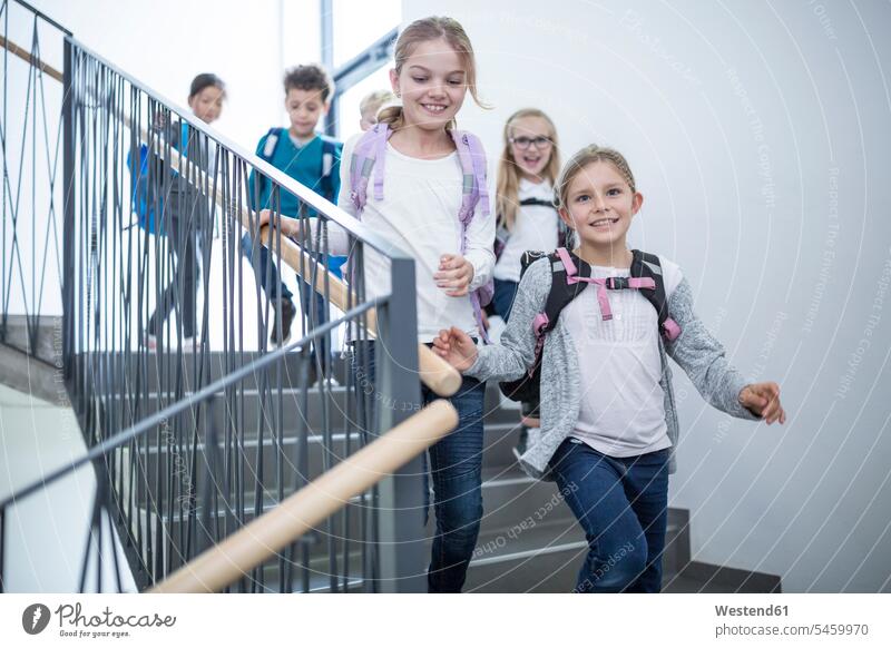 Happy pupils on staircase leaving school happiness happy schools leave student staircases stairwell schoolchildren education casual leisure wear casual clothing